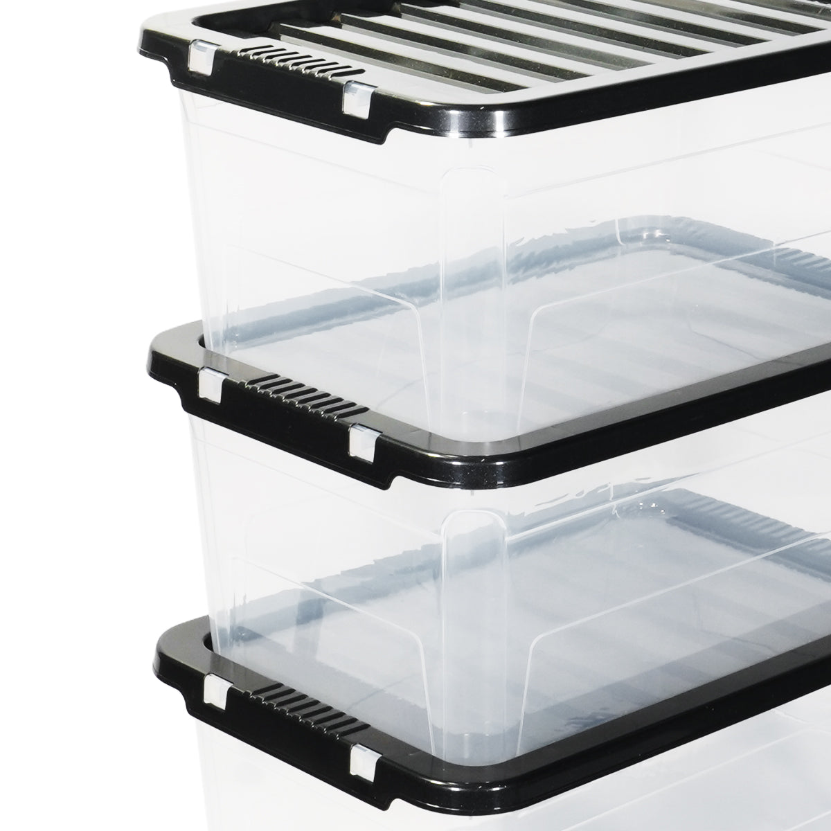 Stack of clear storage bins with black lids on a white background